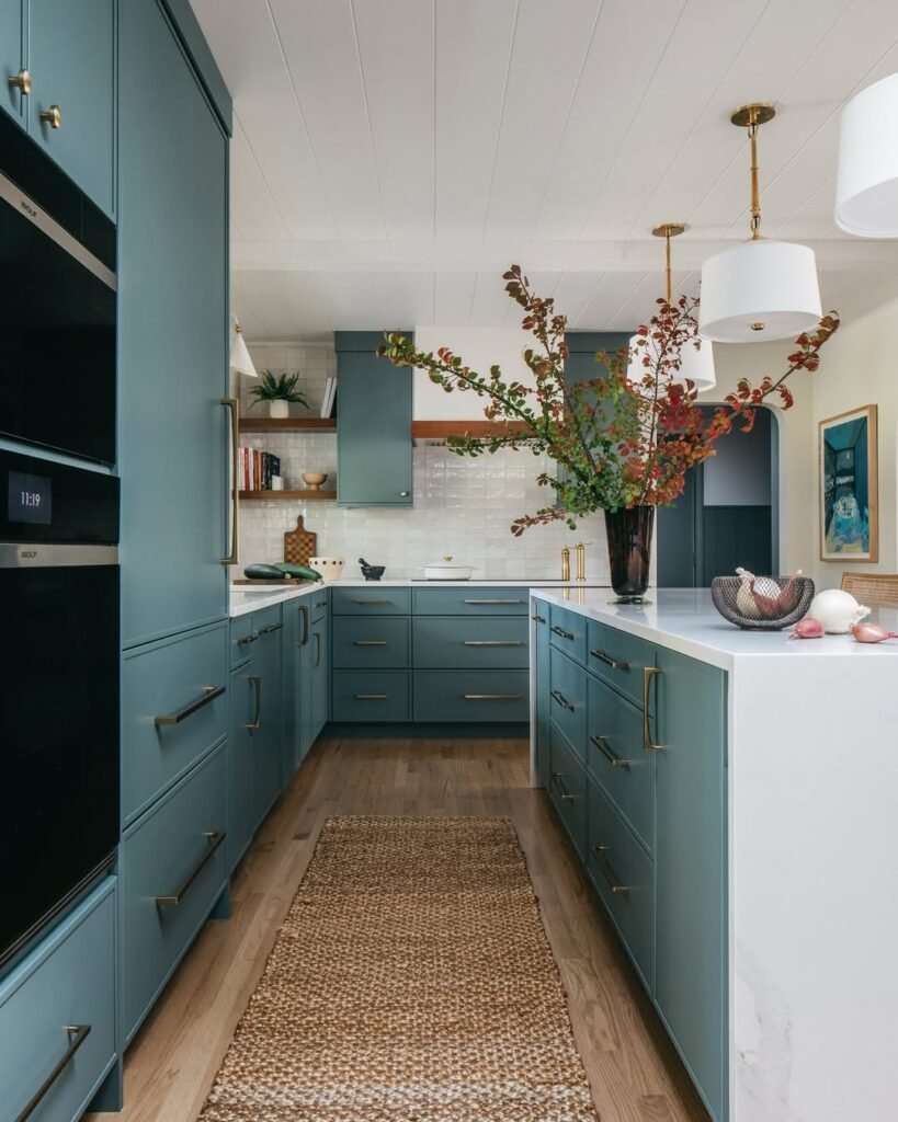 moody closed kitchen with blue cabinets, and white tiles