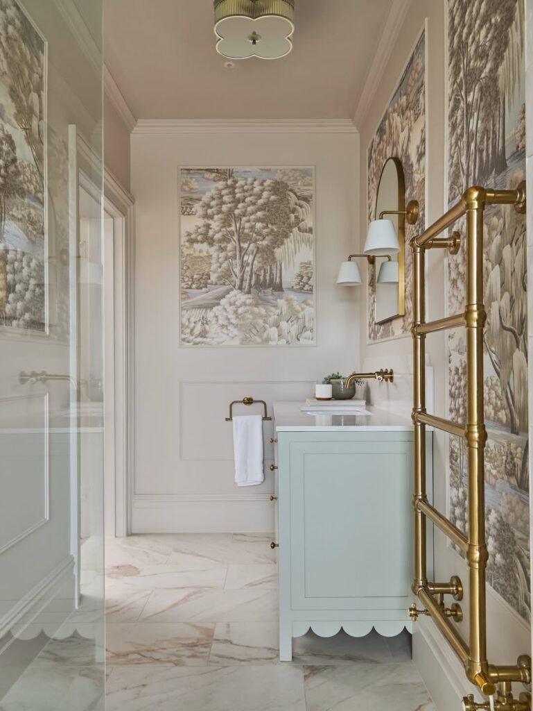 beautiful bathroom idea with brass faucets brass towel dryer, and wallpaper in walls