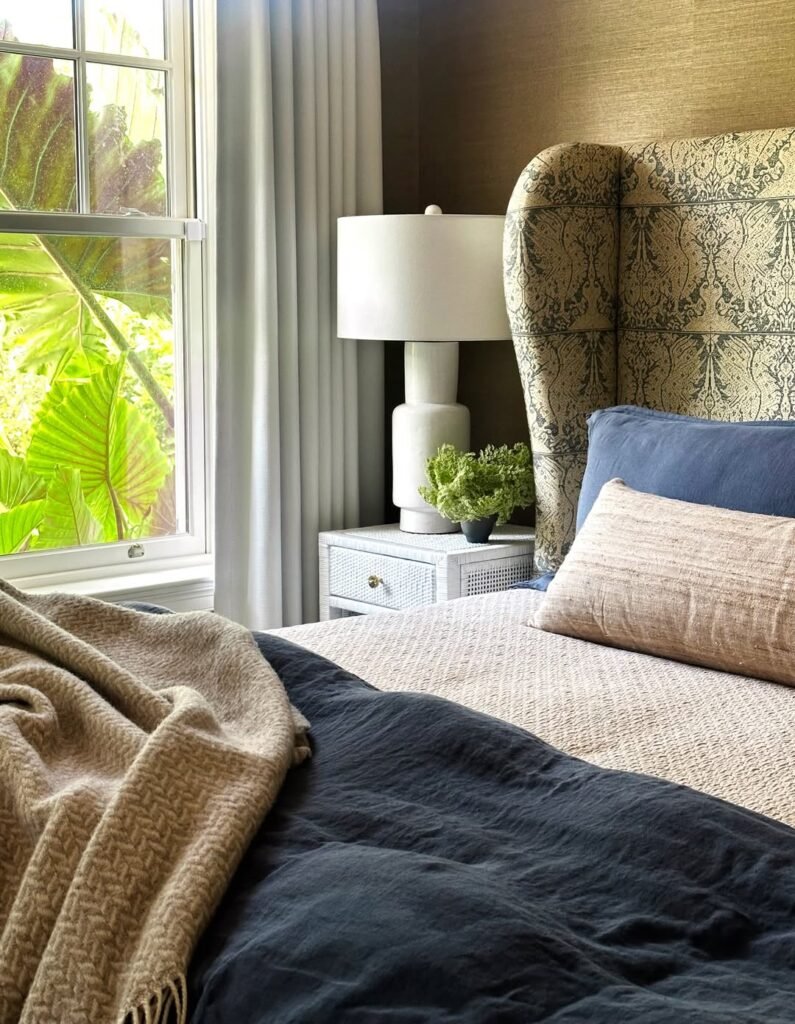 bedroom with a throw and a fabric headbord