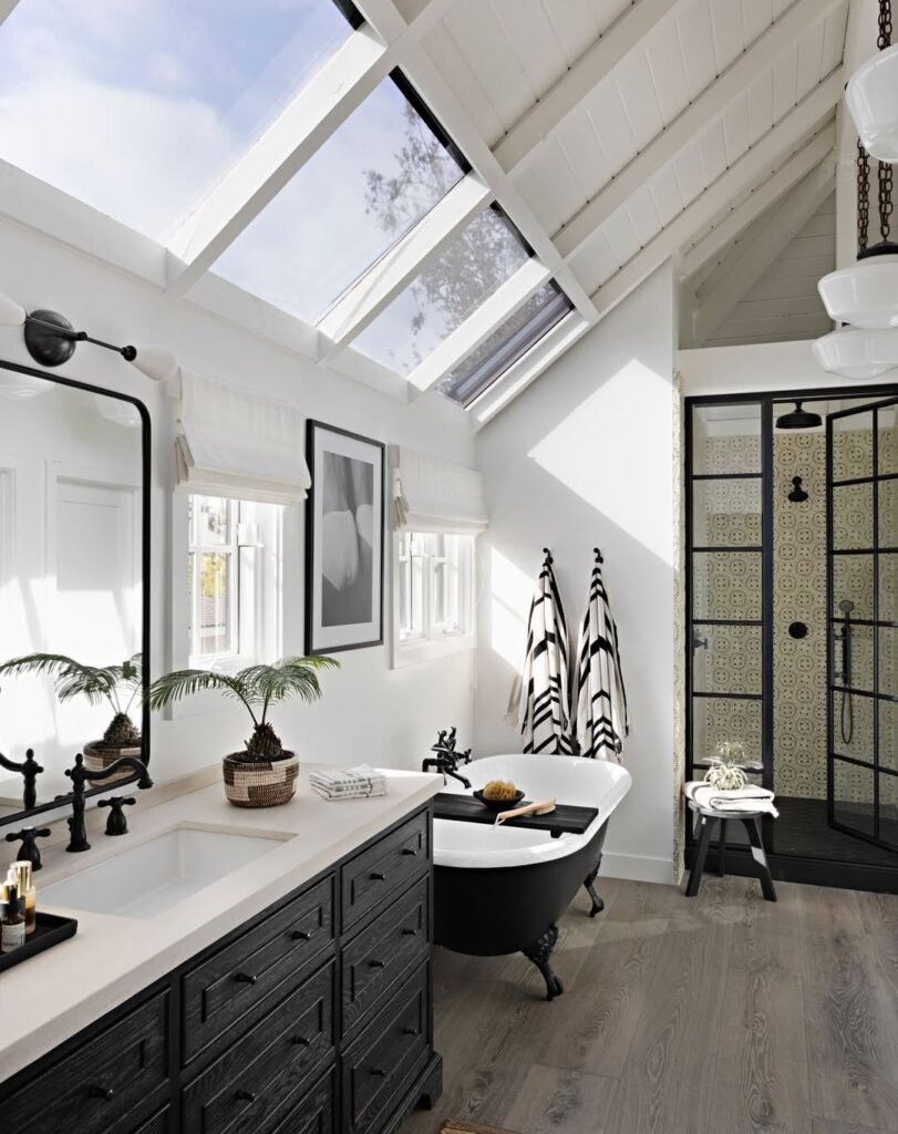 stunning bathroom space with dark wood vanity and black trims