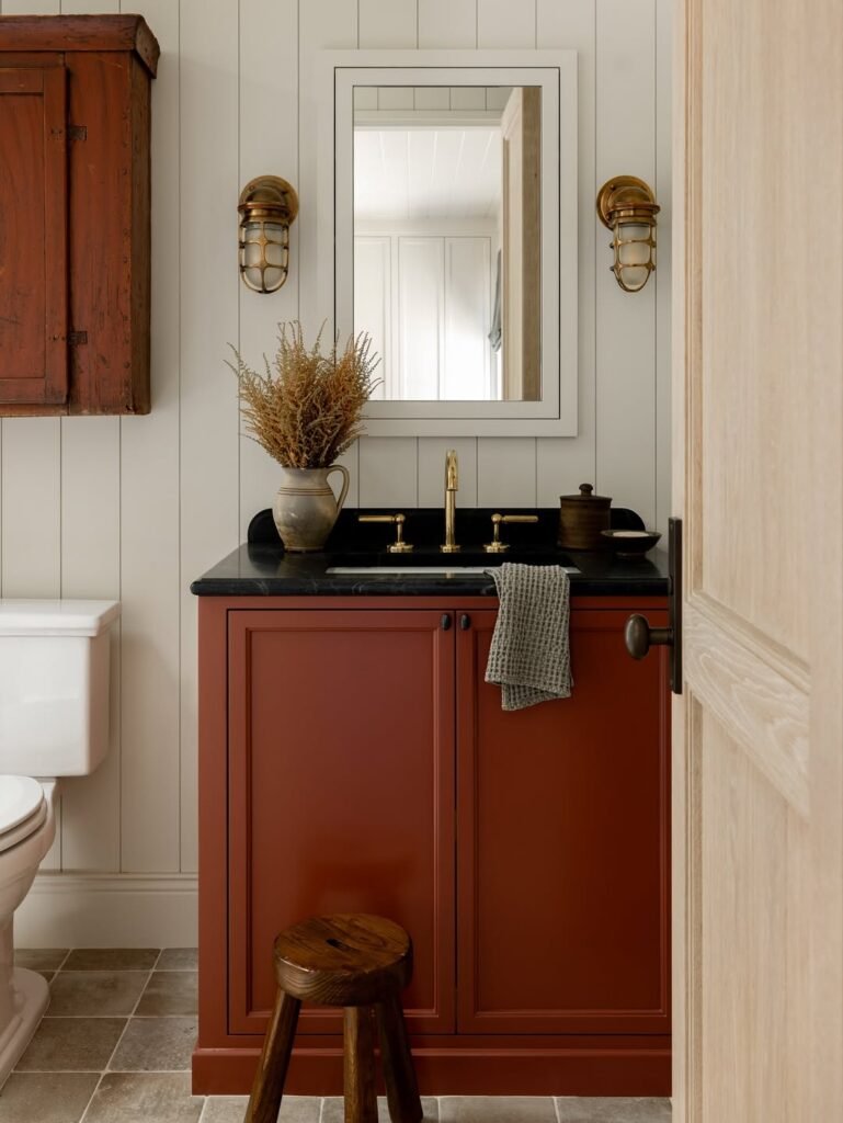 stunning bathroom with teracota red painted cabinets