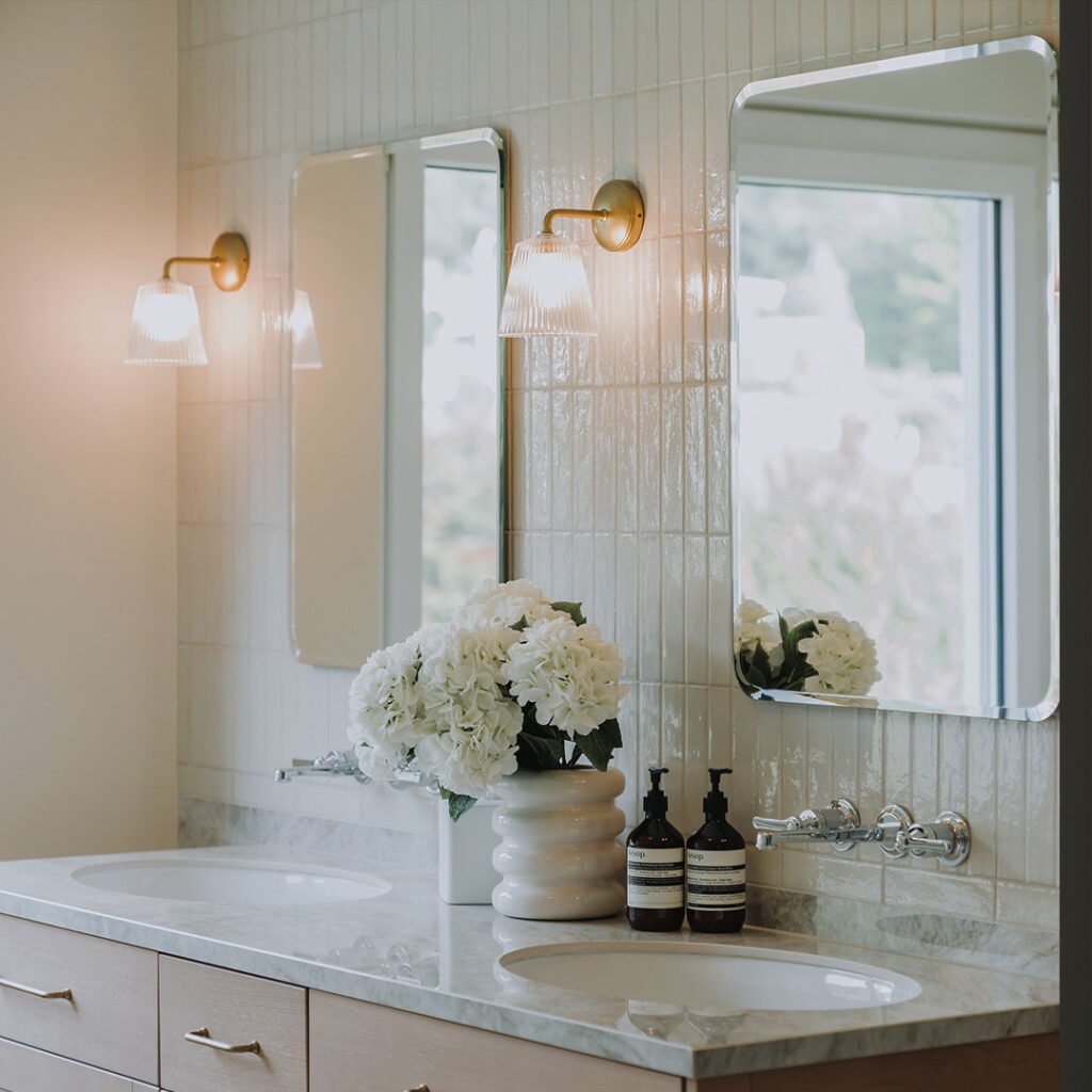 well designed bathroom with brass wall lights